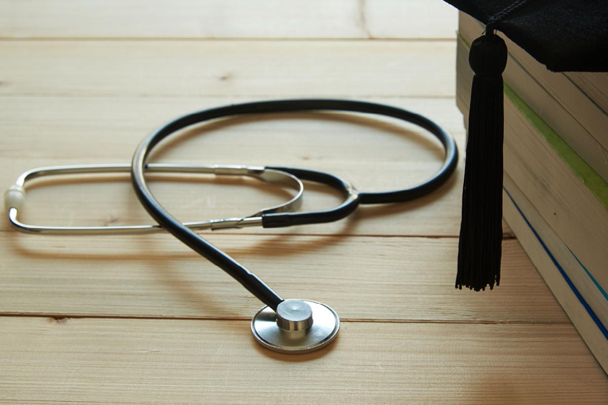 Stethoscope next to graduation cap