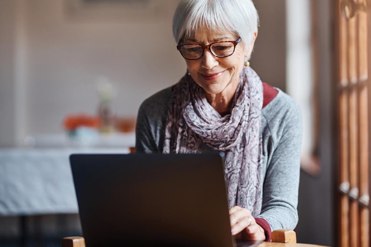 Woman looking at computer smiling