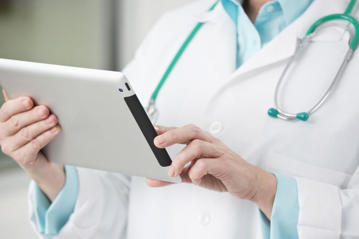 Physician holding tablet