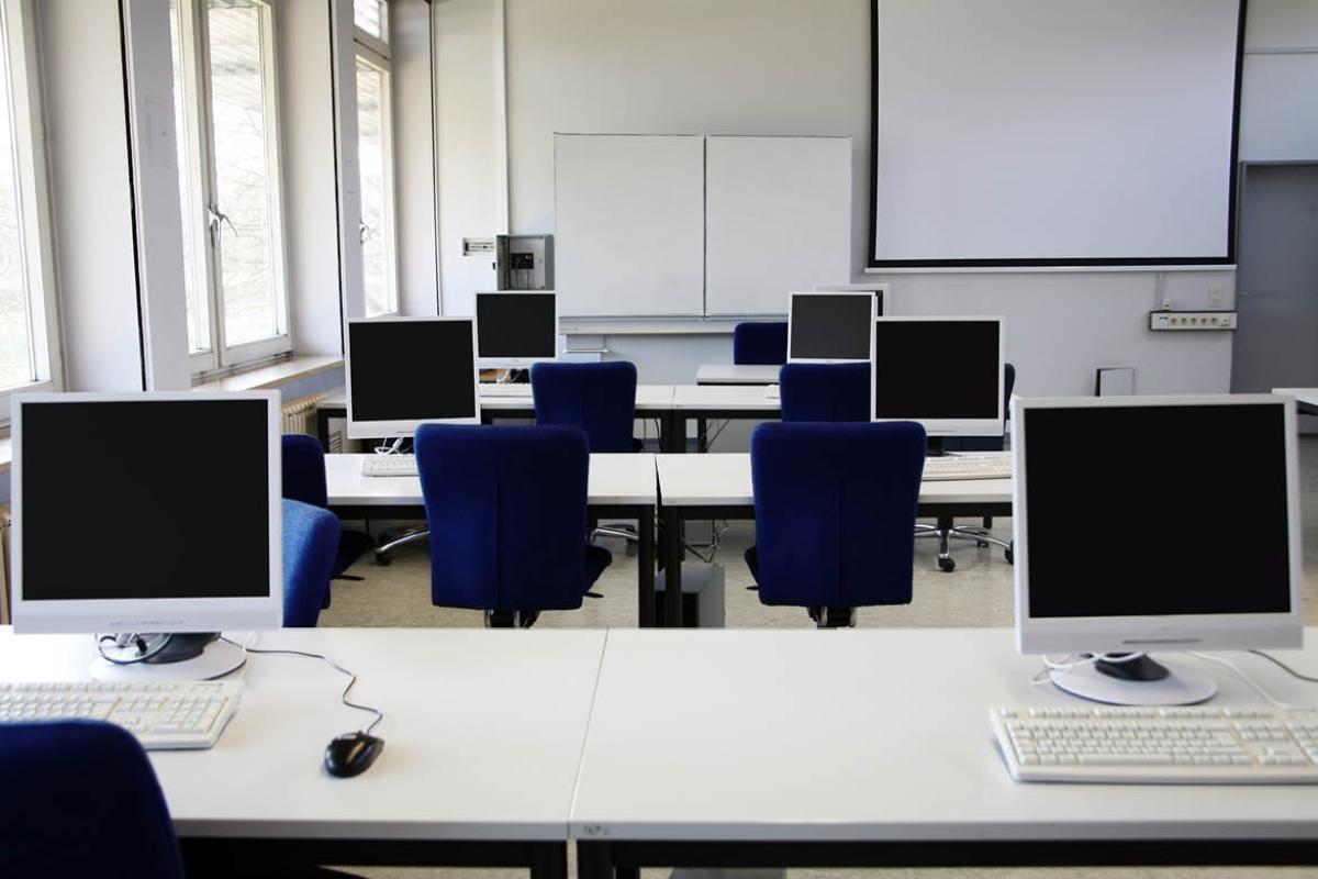 Empty room with desks and chairs