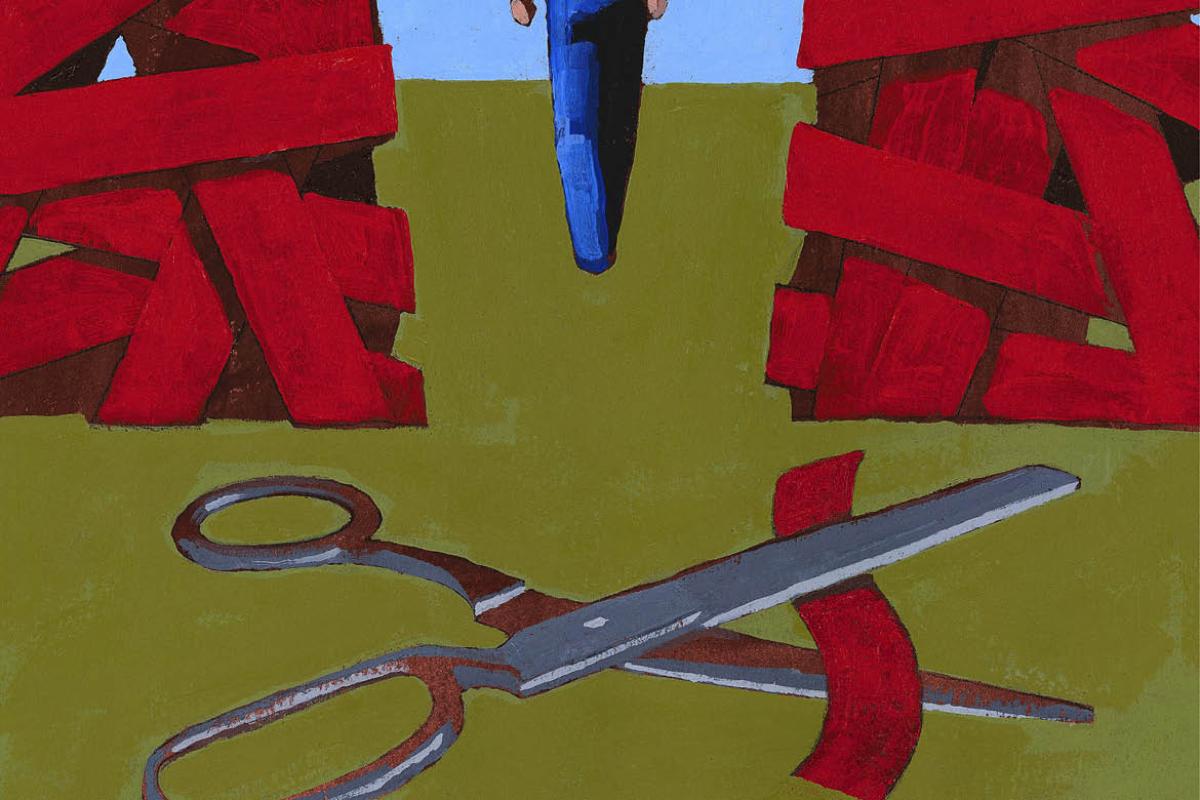 Scissor cutting through red tape