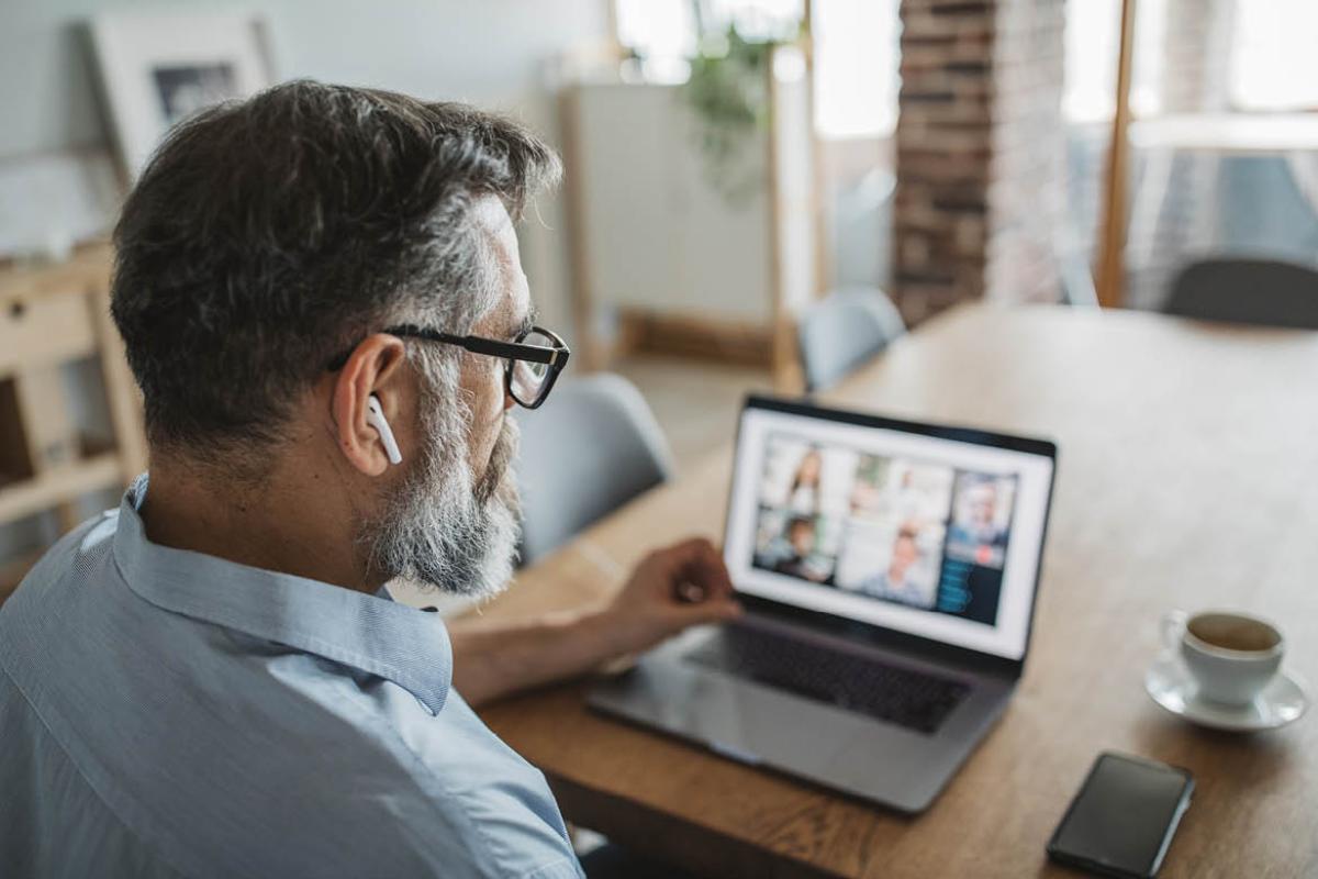 Person having a virtual meeting on a laptop