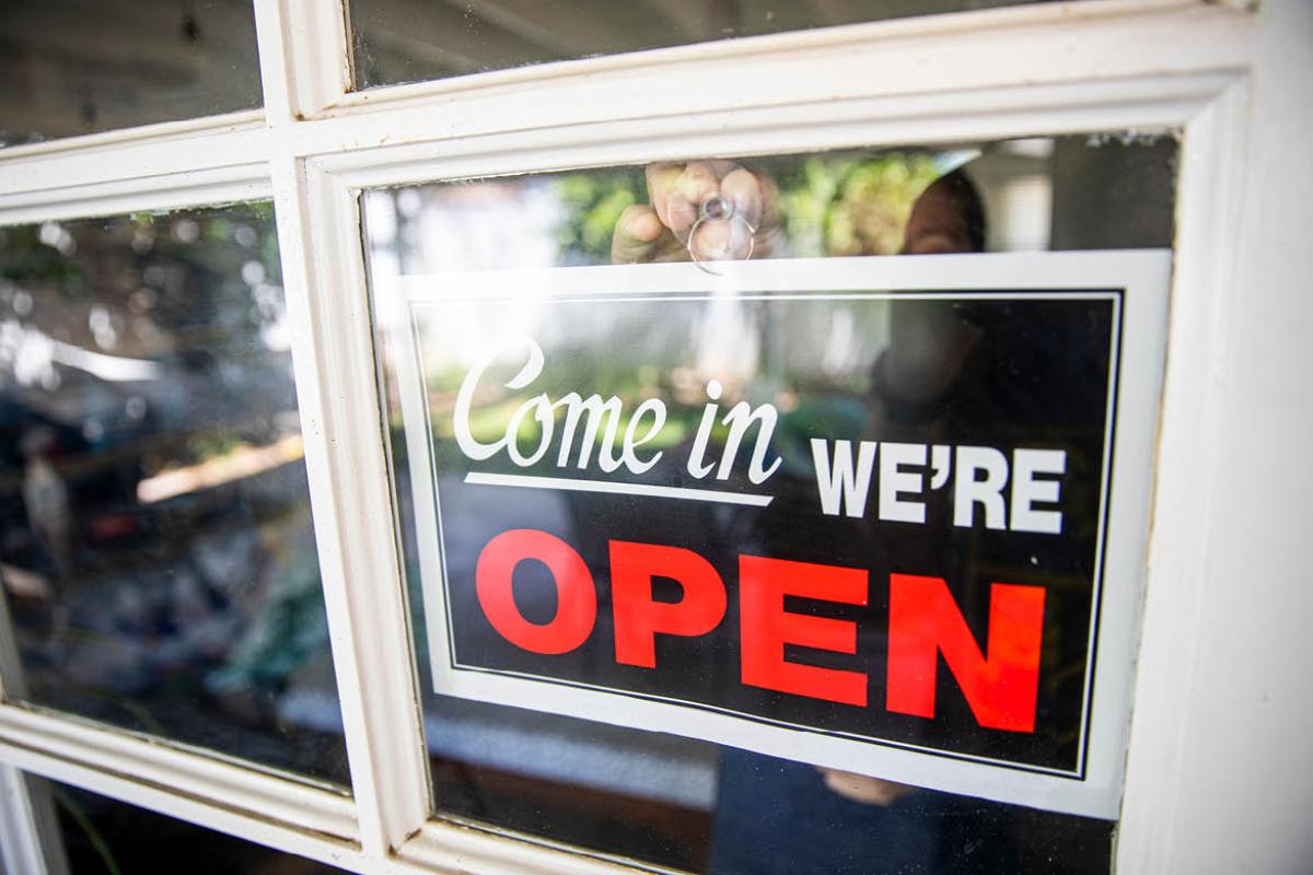 Storefront sign with the words "Come in we're open"