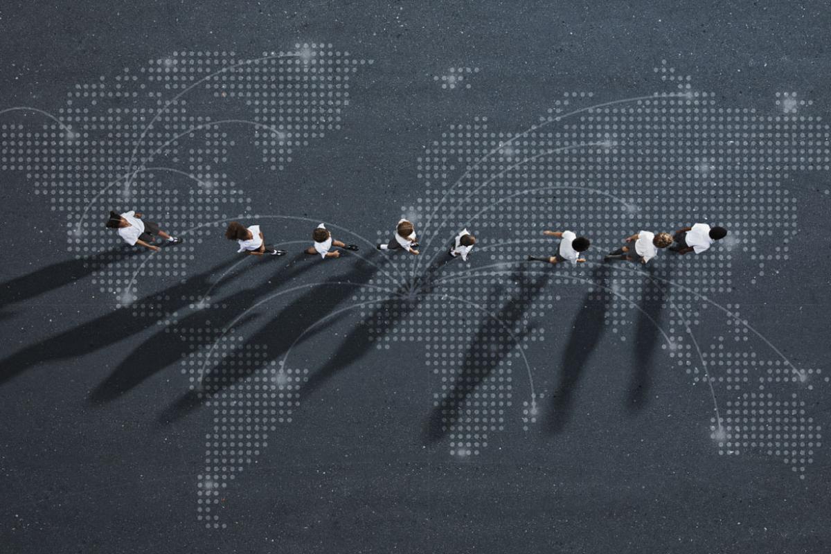 Line of people imposed over an international map