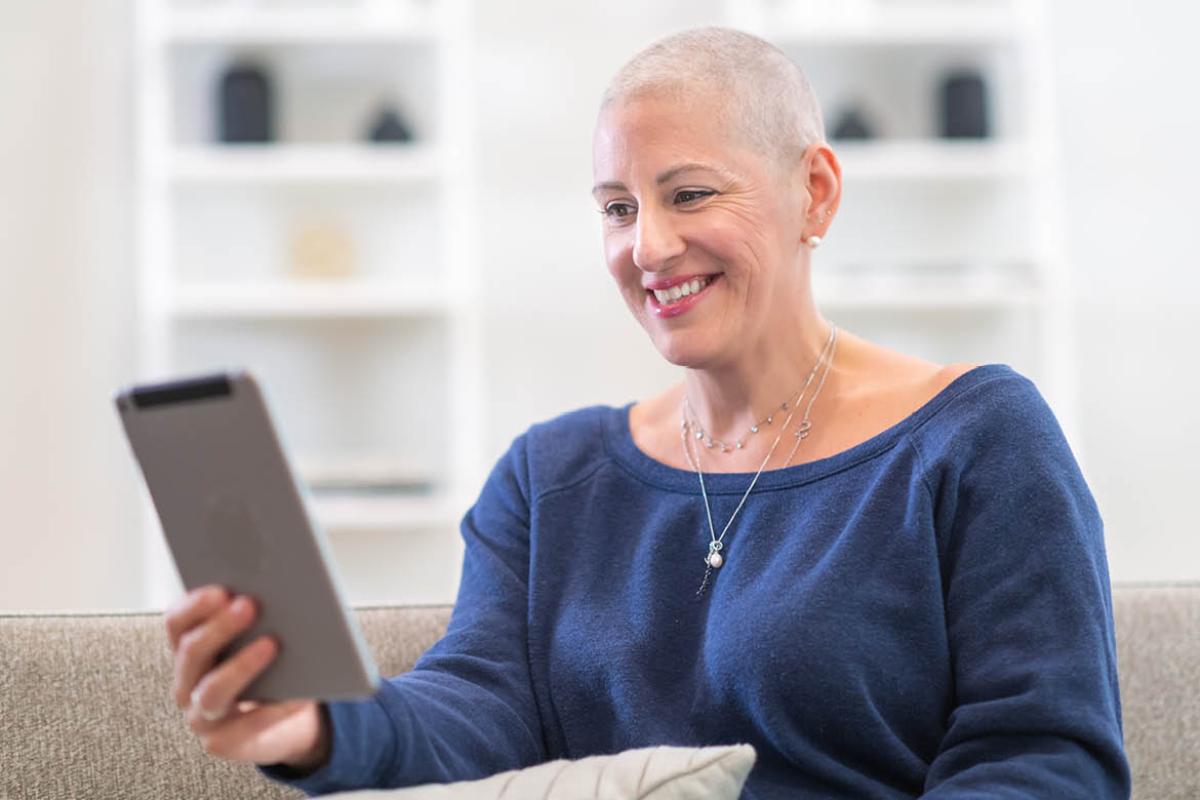 Smiling woman holding tablet