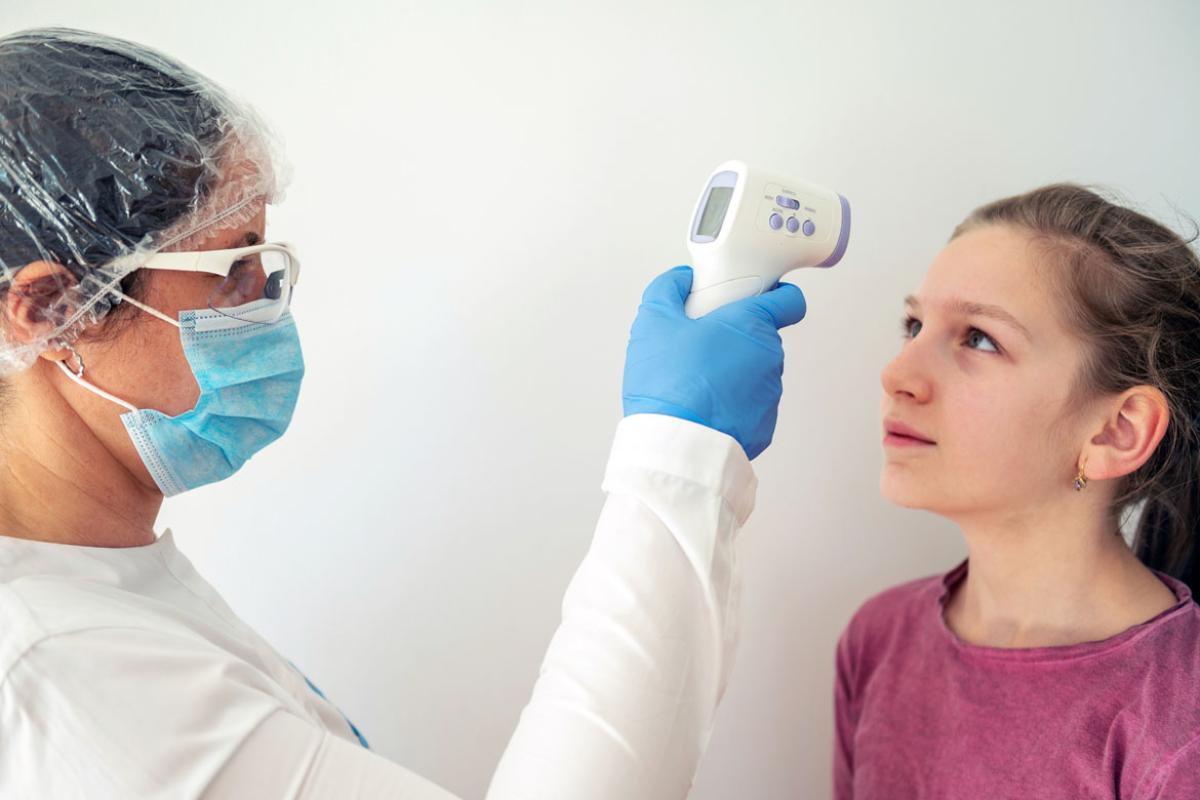 Young patient having temperature taken