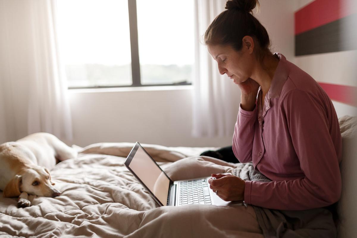 Woman in bed with laptop