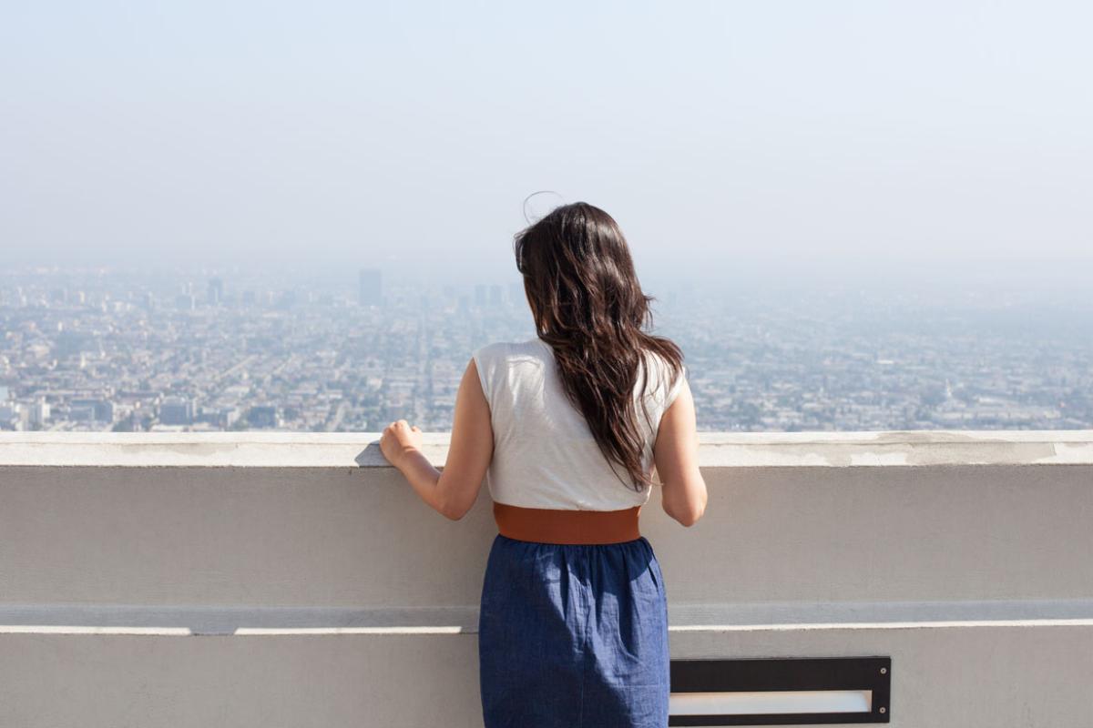 Person looking out at a cityscape