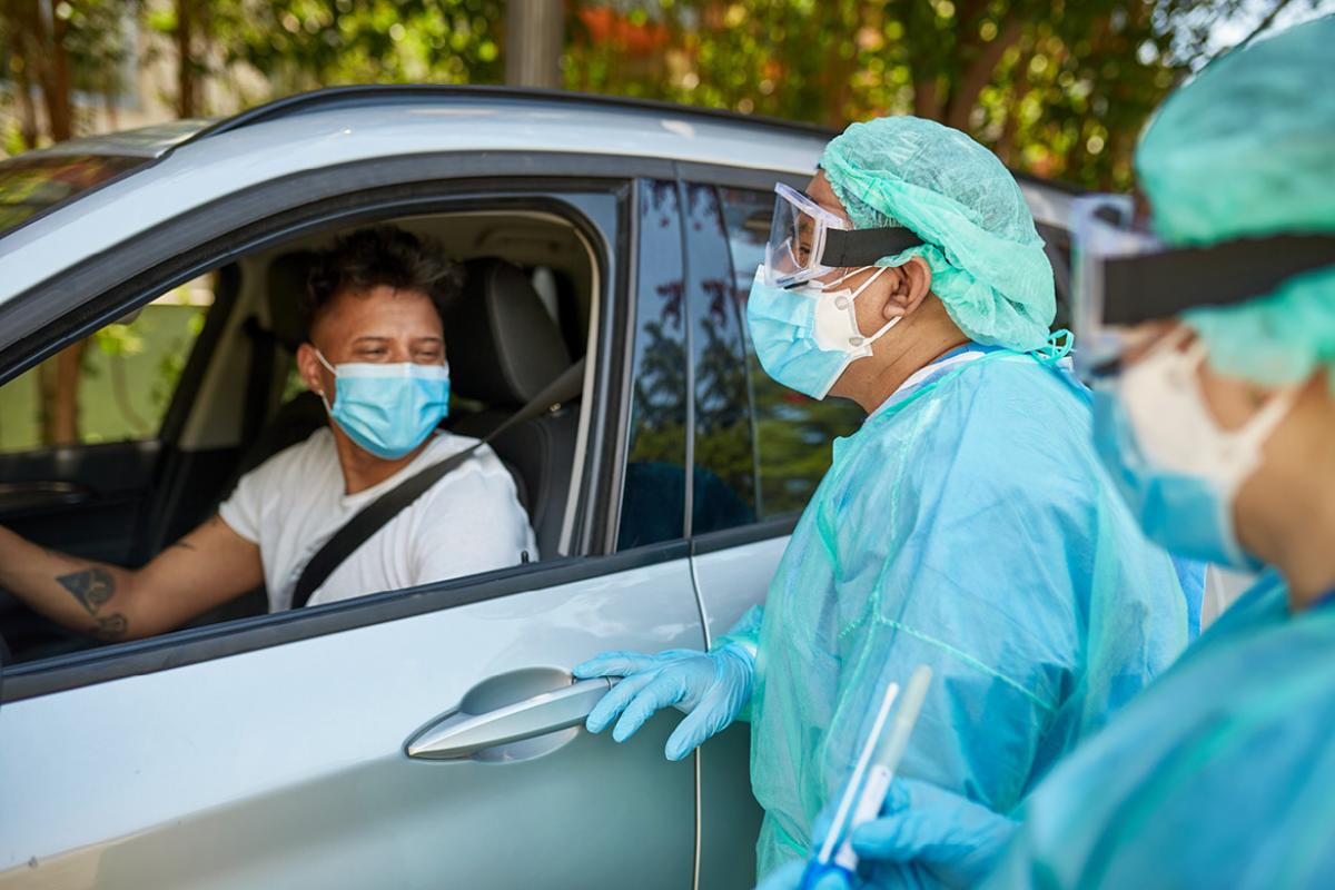 Person in car wearing a face mask