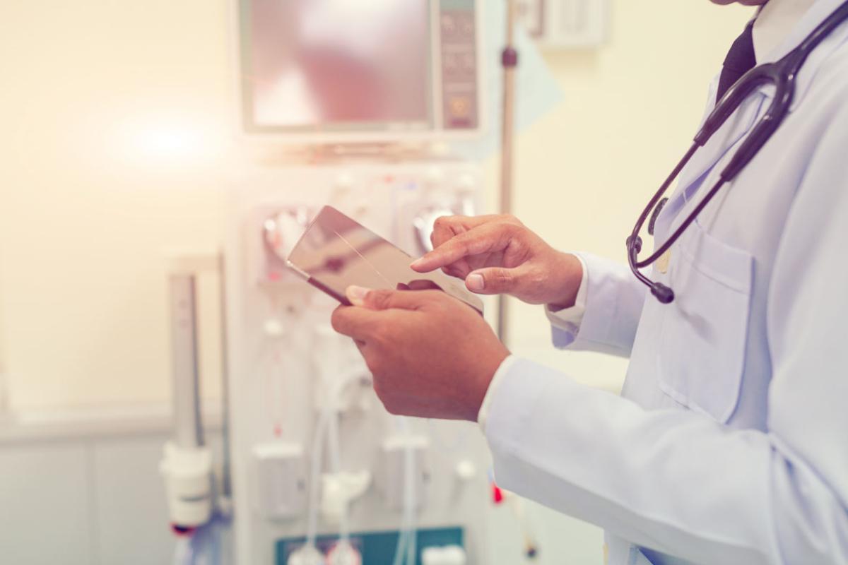 Close-up of a physician consulting a smartpad