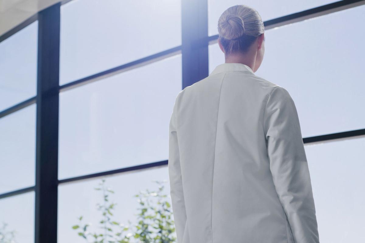 A physician looking out a window