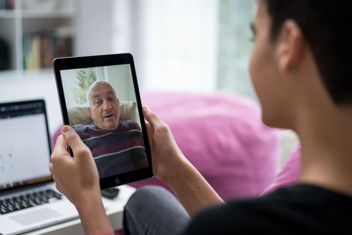 Two people conversing via a tablet