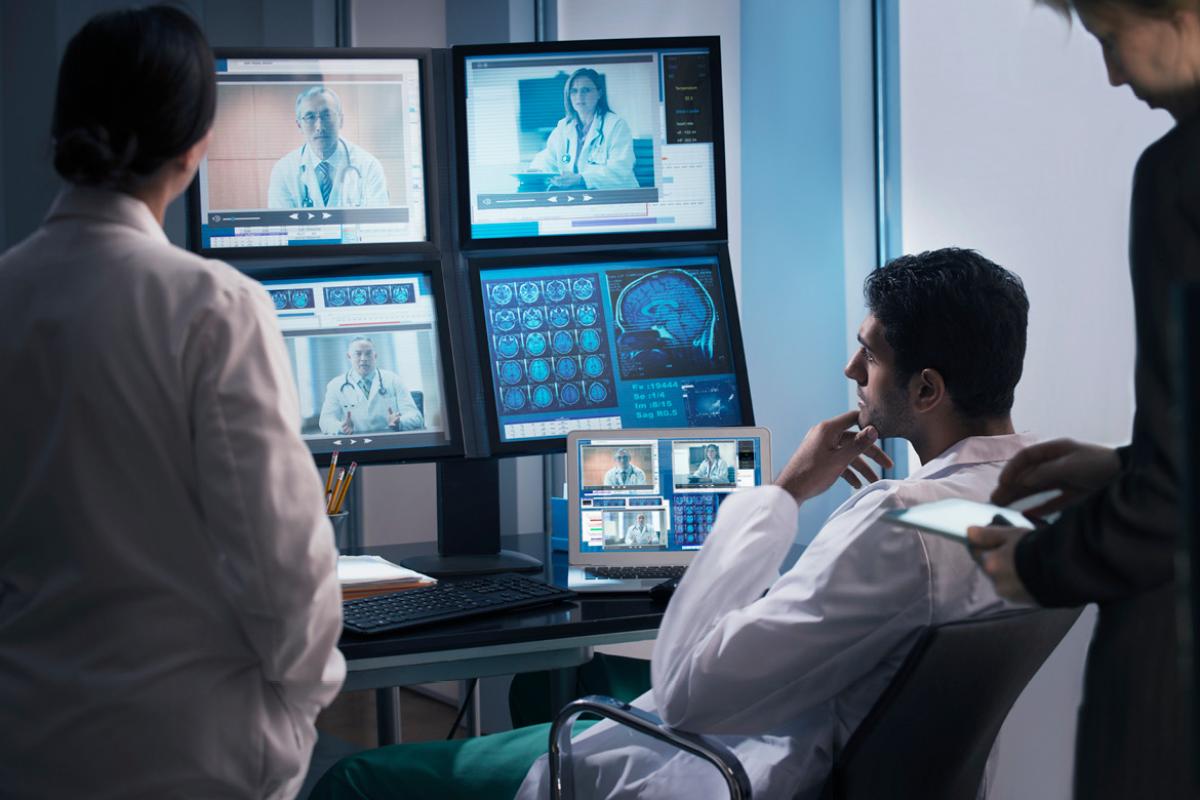 A group of physicians conferring by teleconference