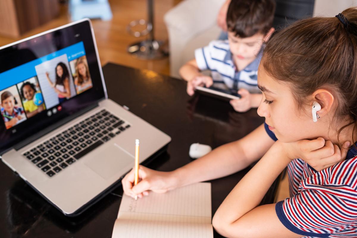 Young children working at a laptop