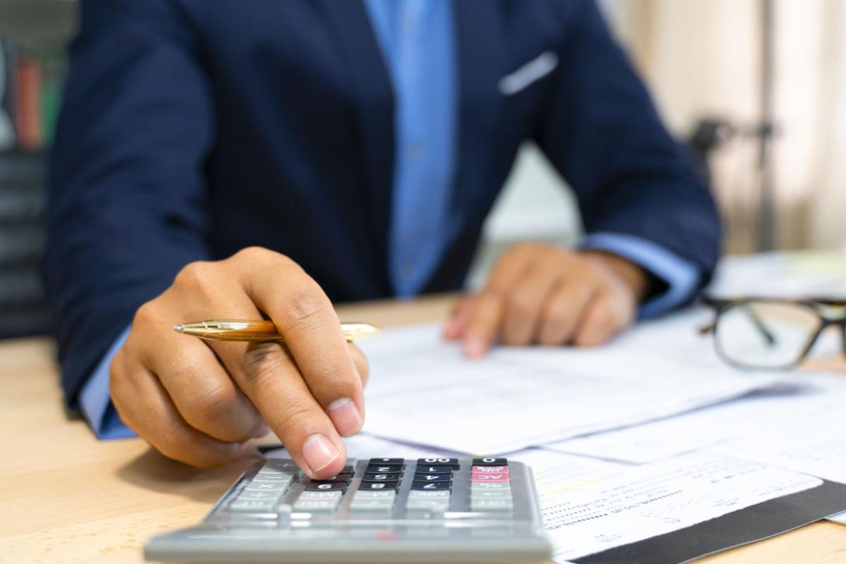 Close-up of hands using a calculator