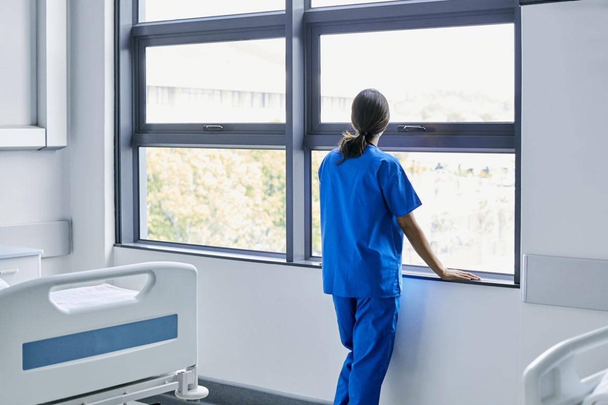 Physician looking out a window