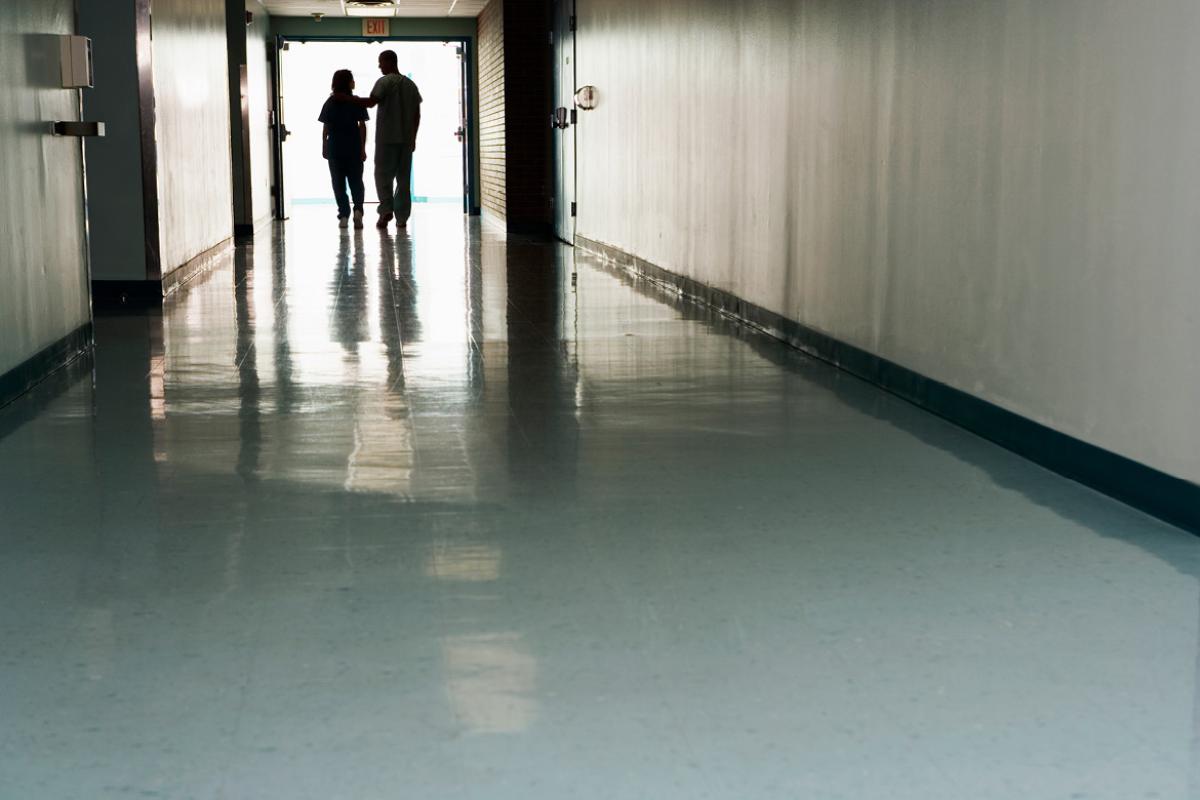 Silhouette of a pair of health care workers in a hallway