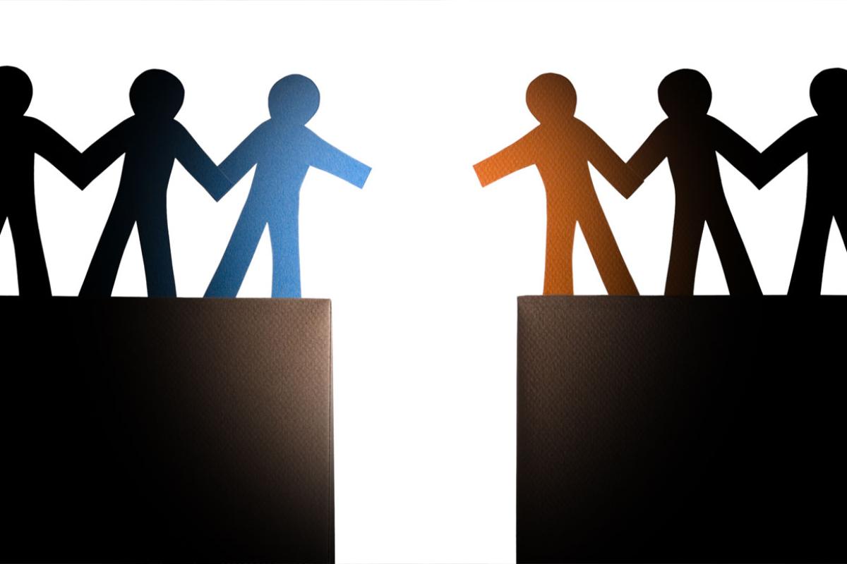 An illustration of a chain of people holding hands reaching out to each other over a gulf.