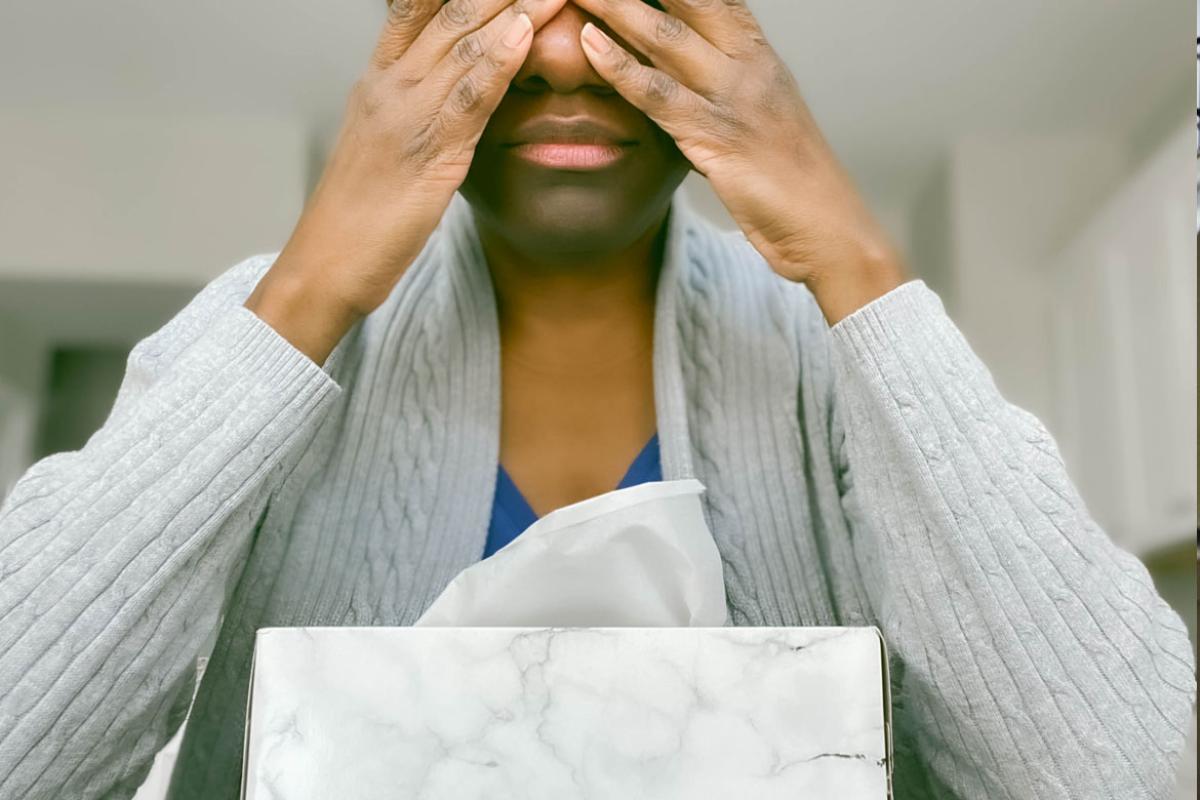 Person with hands over eyes.