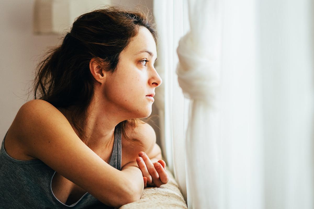 Woman looking out of window.