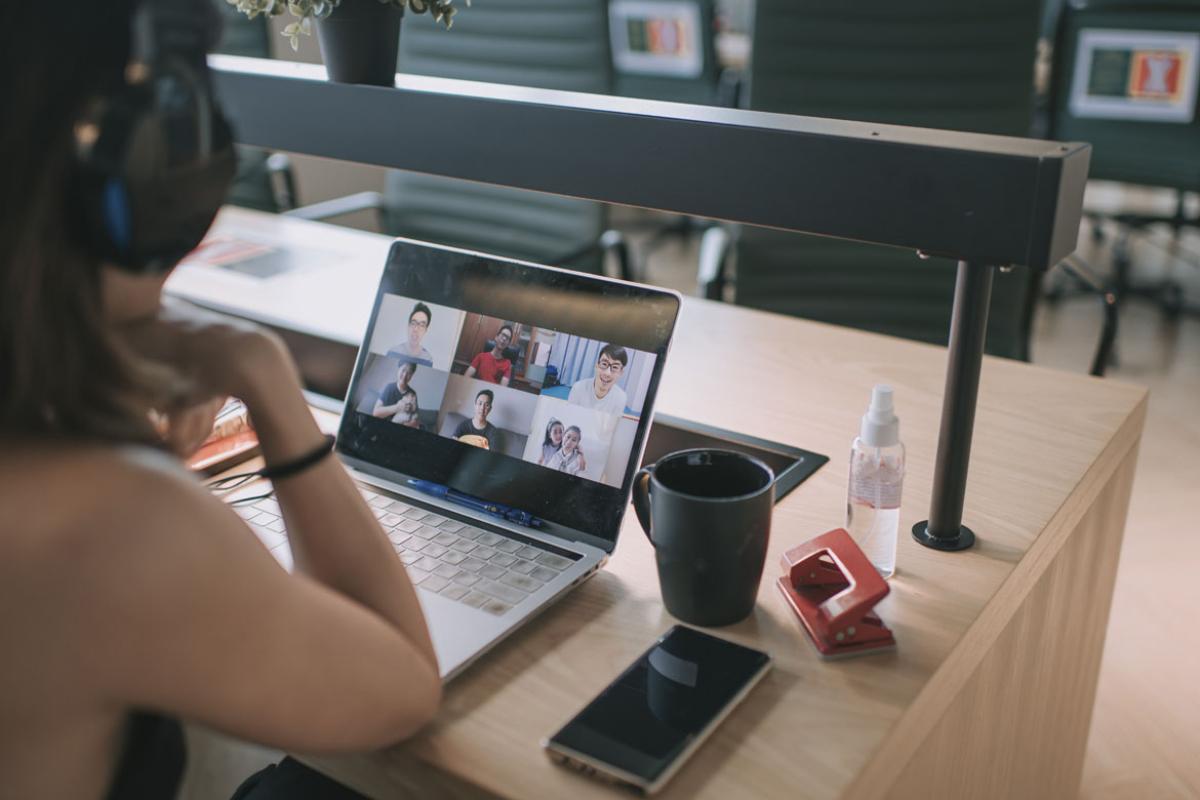 Person having a virtual meeting on a laptop