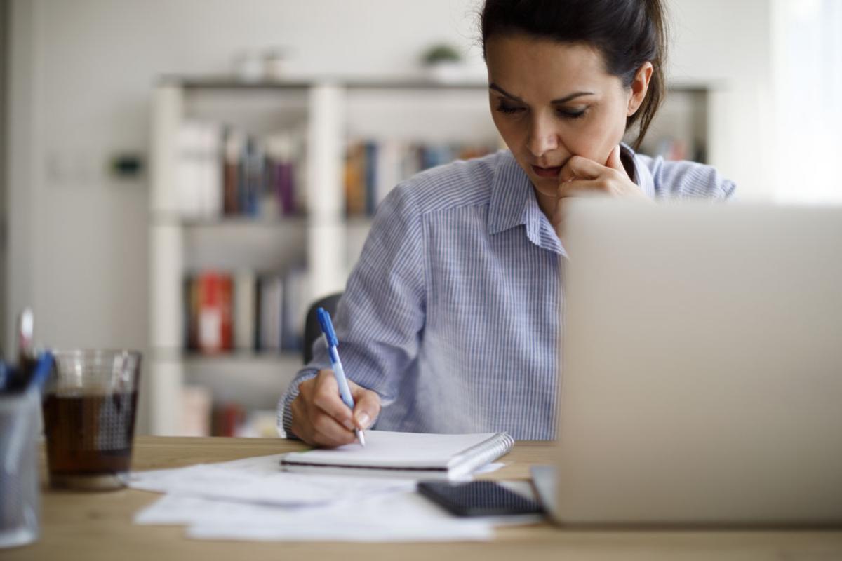 Woman writing on a note pad