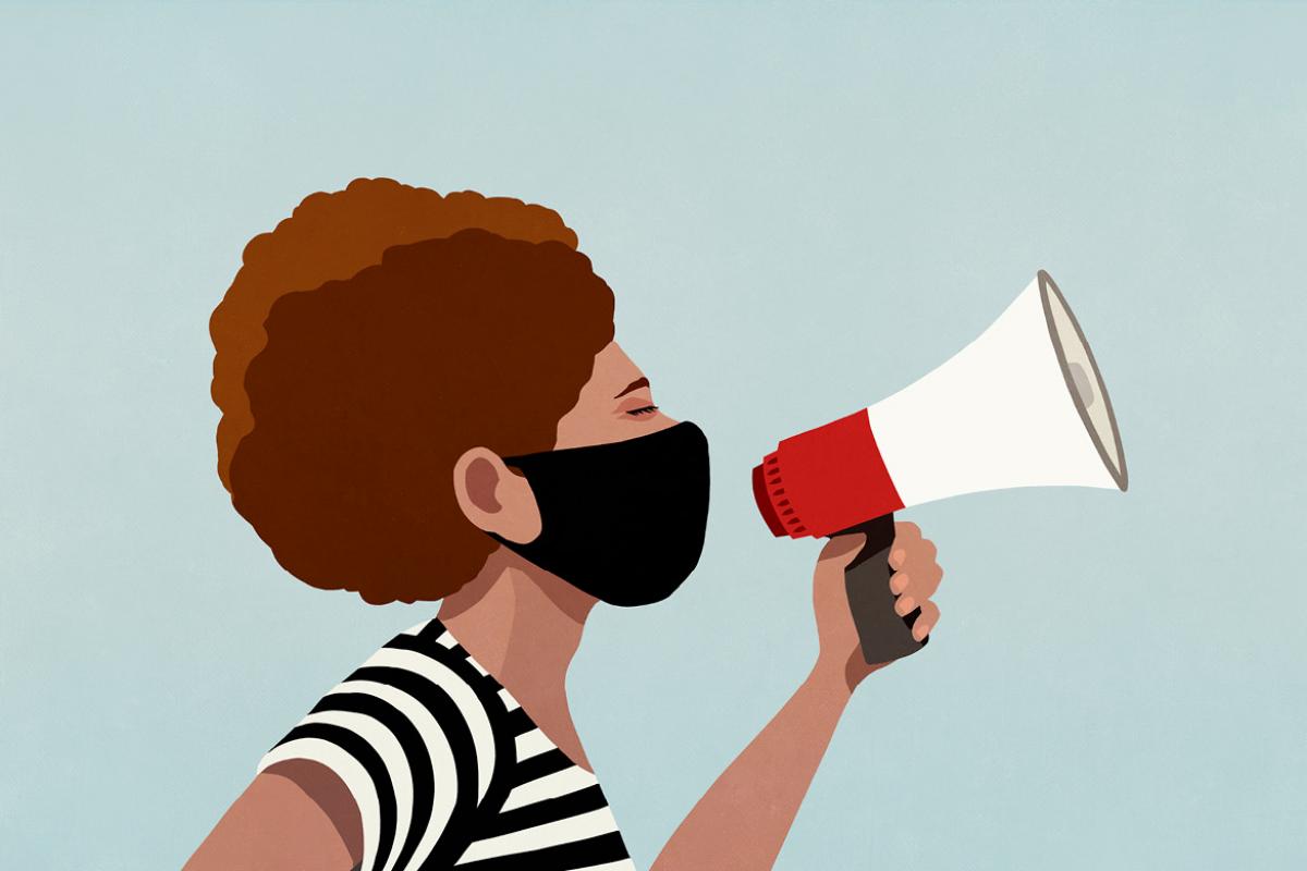 Person in a face mask using a megaphone