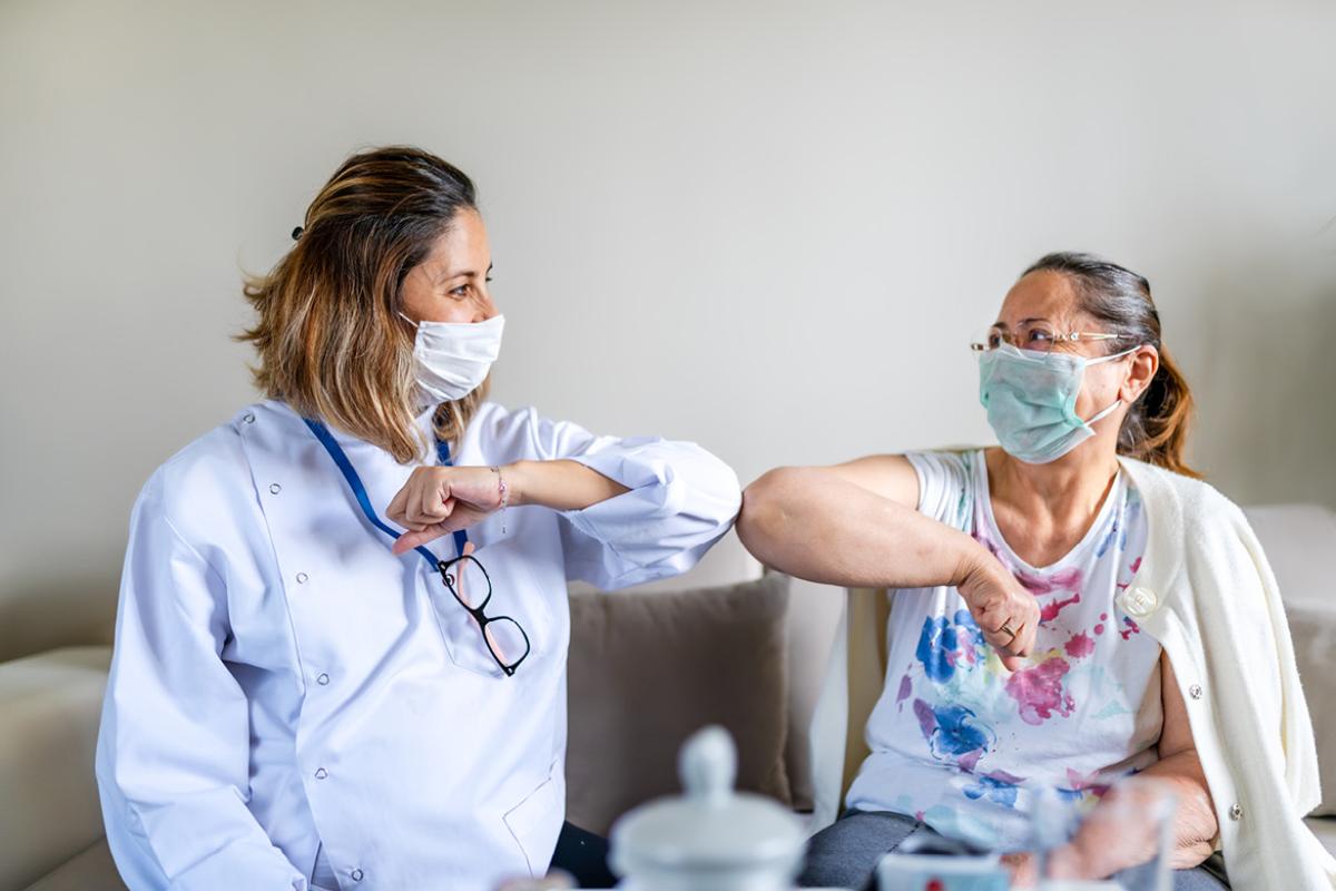Health care work and patient bumping elbows