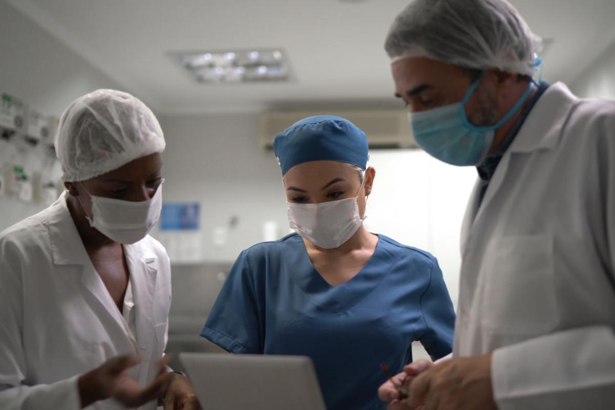 Three doctors looking at documentation