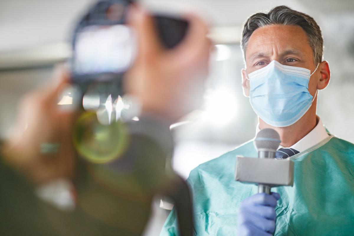 Physician giving an interview in front of the camera in the hospital