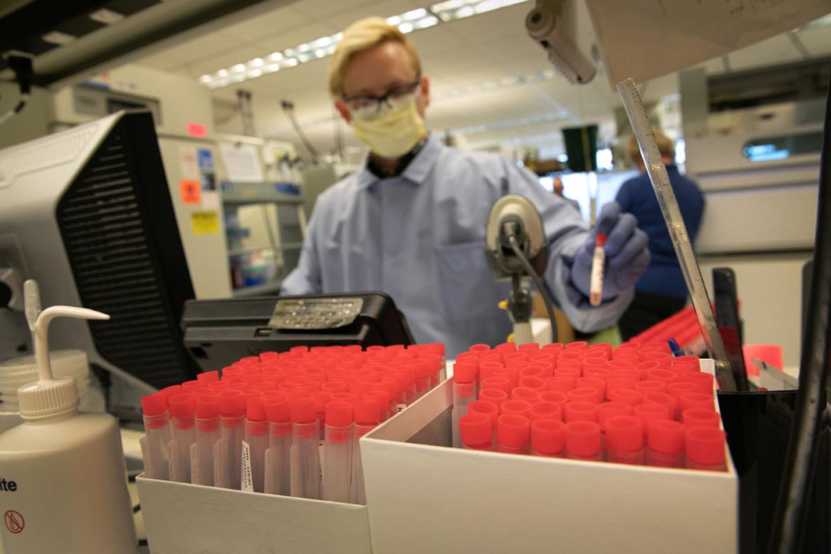 Physician packing vials in a lab