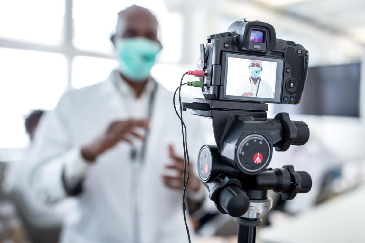 Physician in front of a camera