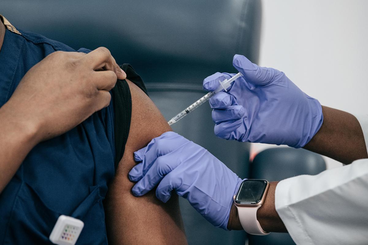 Health care professional receiving vaccine.