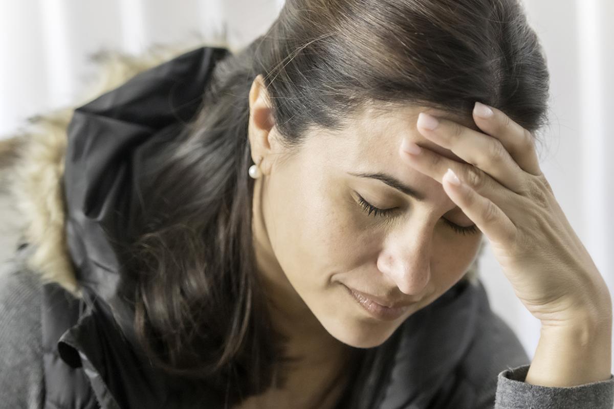 Person with hand on head
