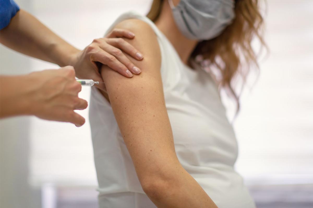 Pregnant person receiving vaccine