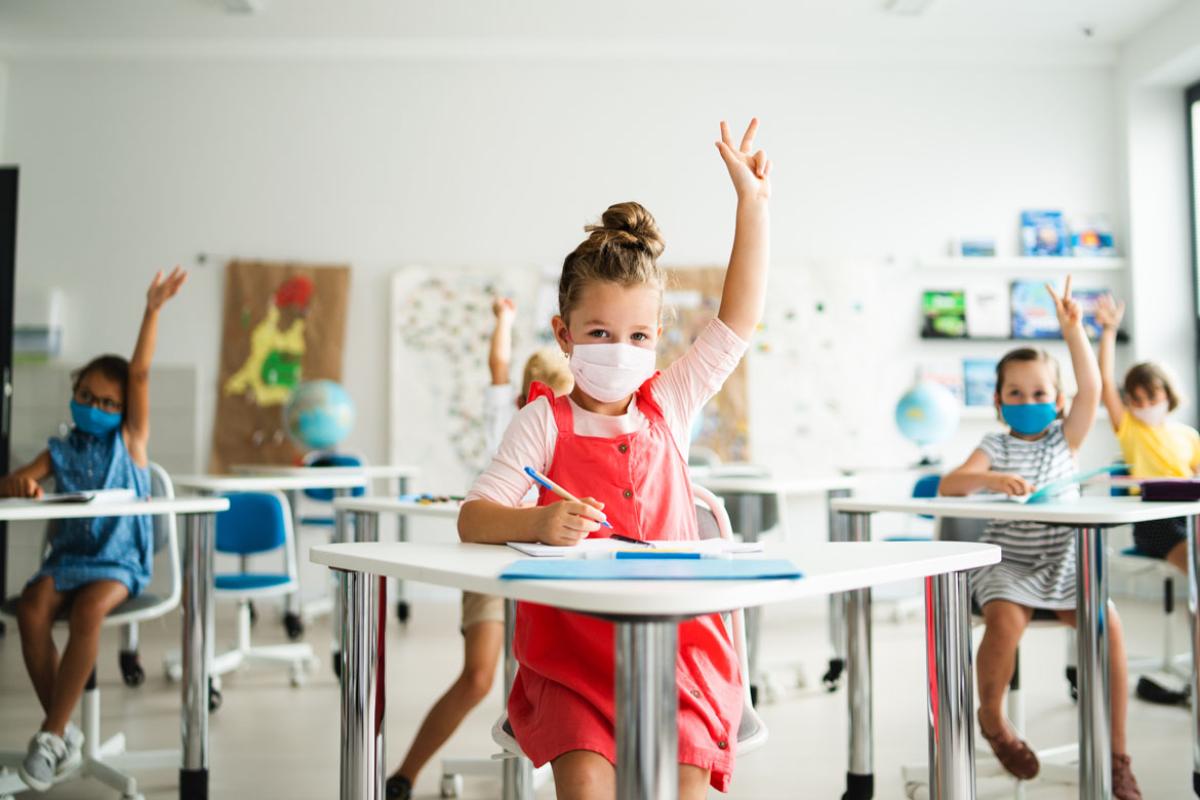Classroom of social distant elementary school children wearing masks.