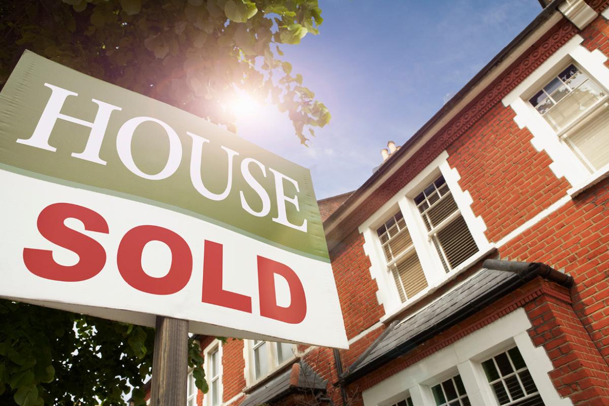 Sold sign in front of house
