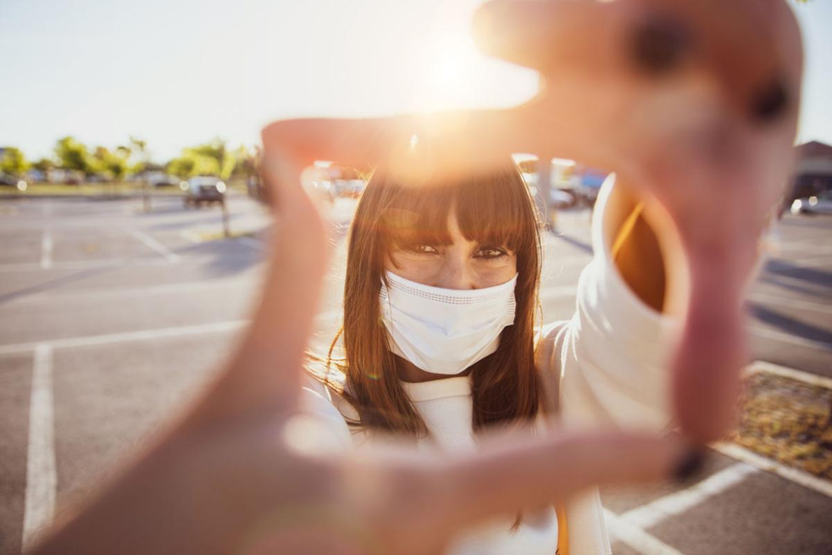 Person smiling behind a face mask