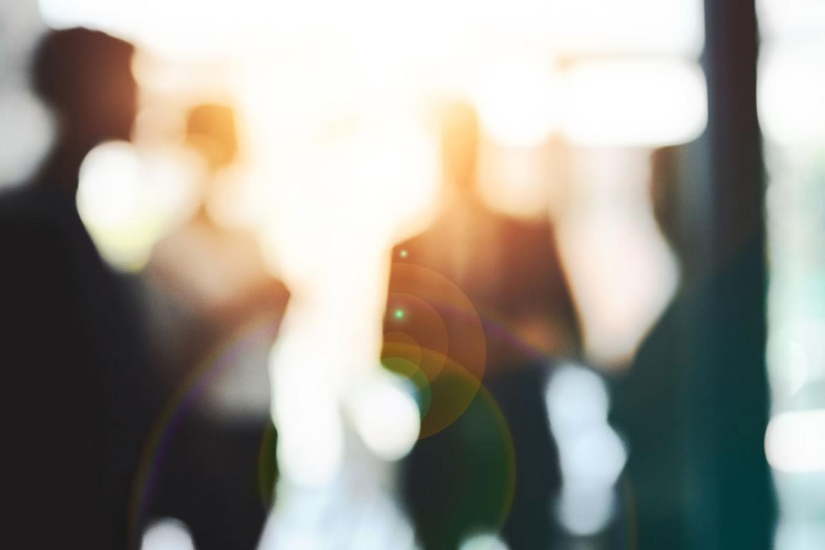 Blurred image for four people in sunlight