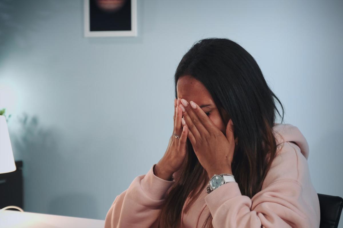 Person with hands on head