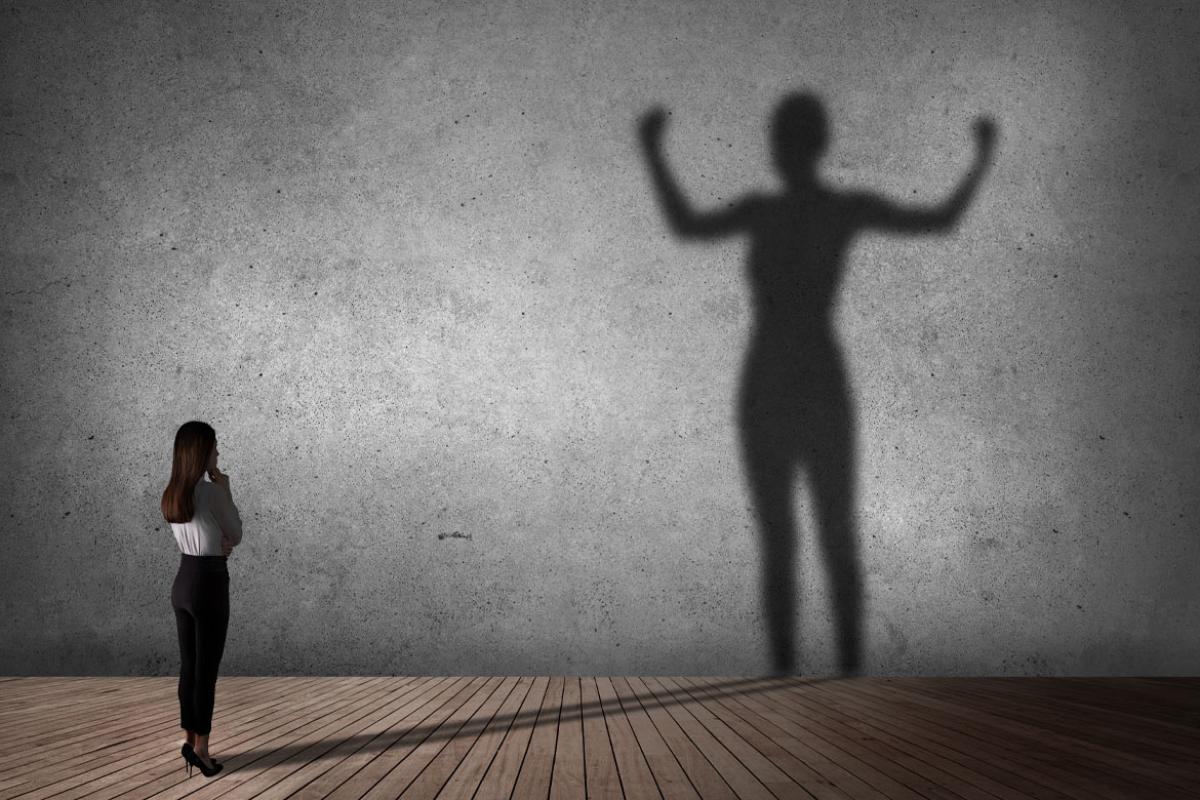 Standing person looking at a shadow