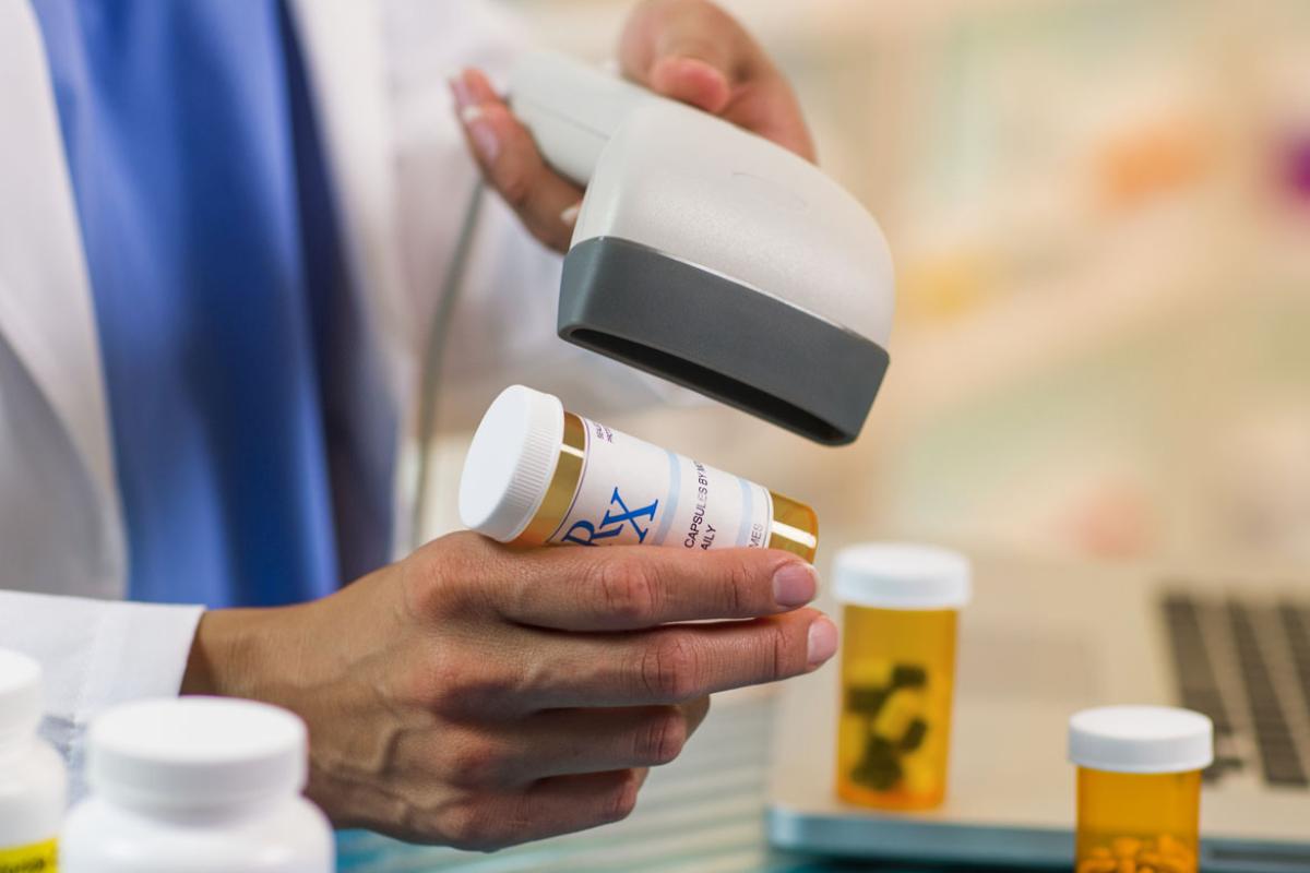 Hand scanning a prescription bottle
