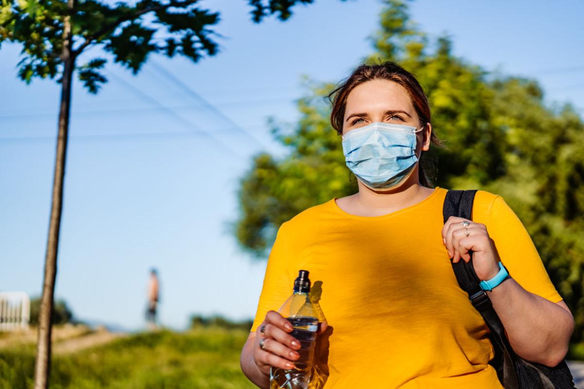 Person wearing a face mask walking outside