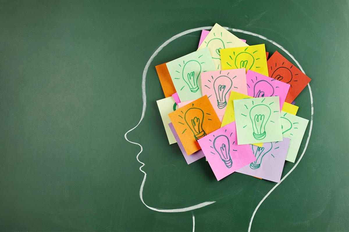 Chalkboard drawing of a head with post-it notes