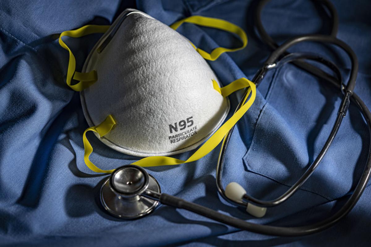 Face mask with stethoscope and scrubs