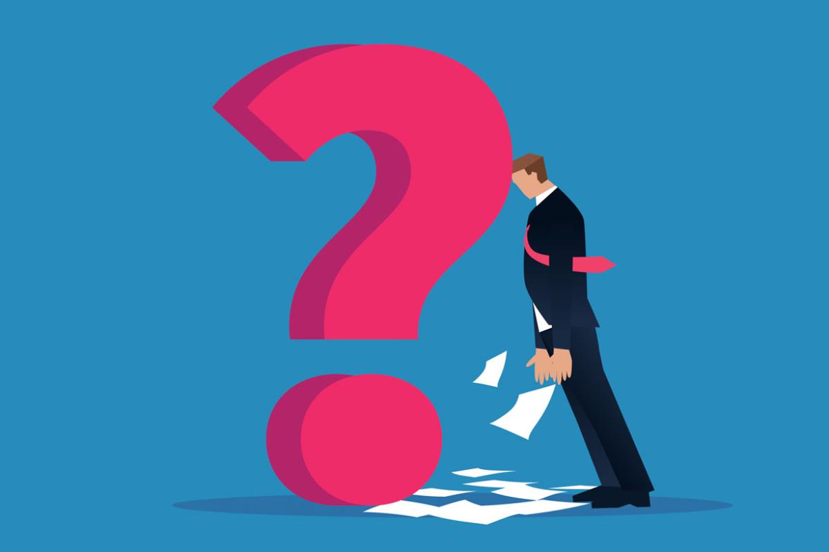 Businessperson leaning on a question mark