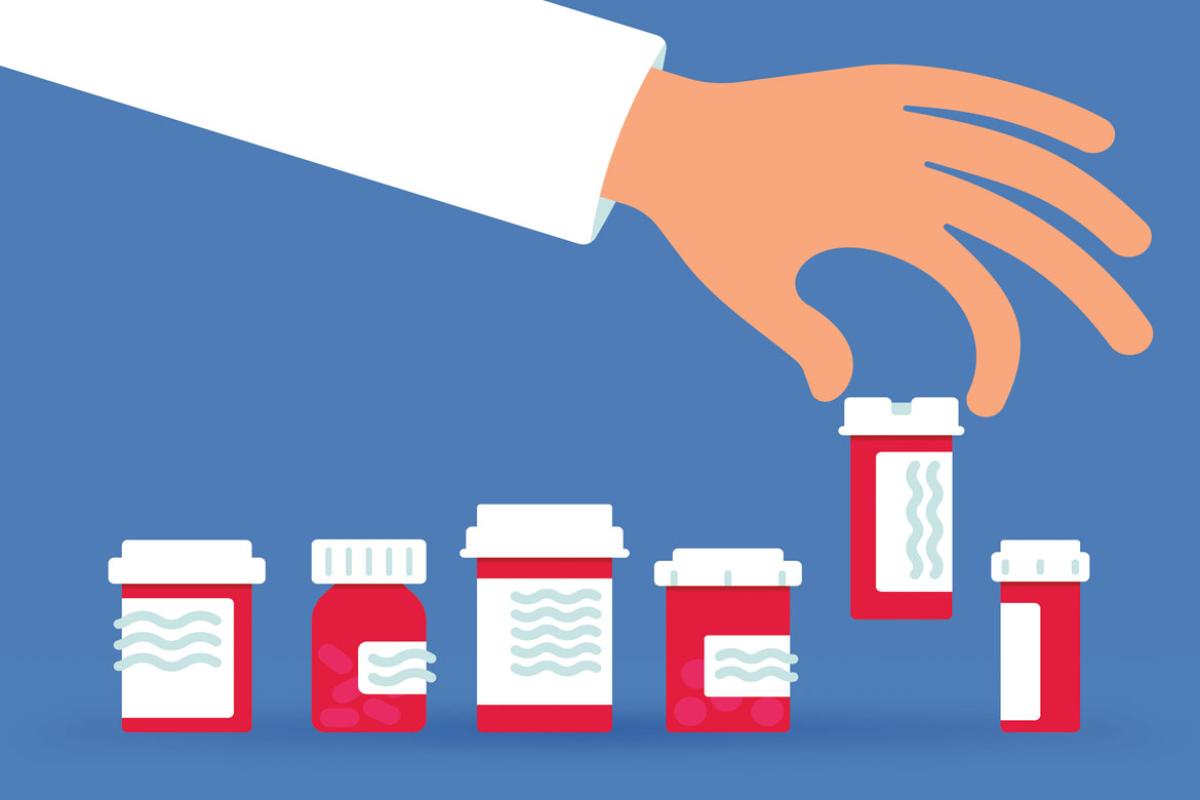 Hand picking up prescription bottle