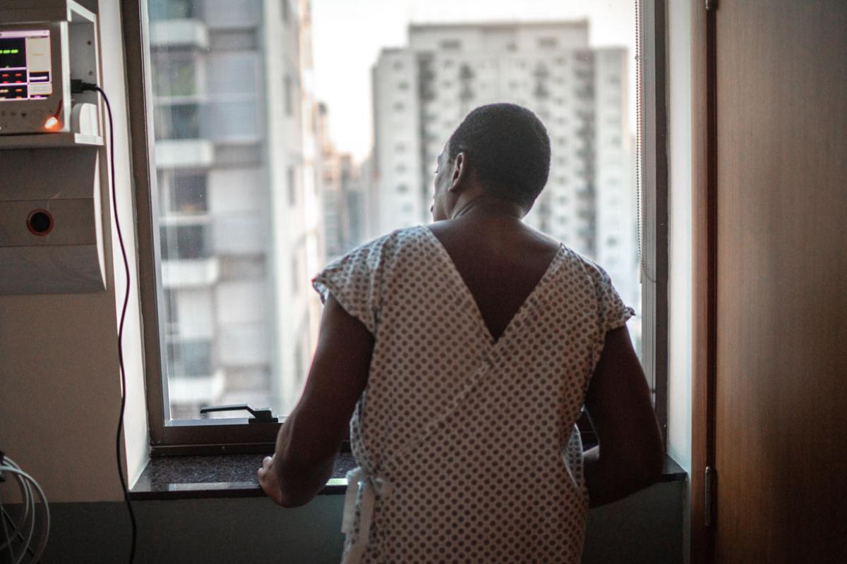 Patient standing in front of window