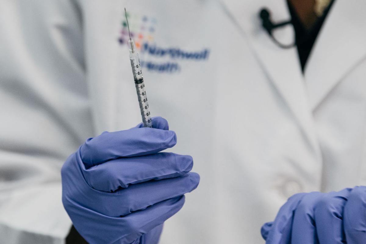 Hand holding a syringe