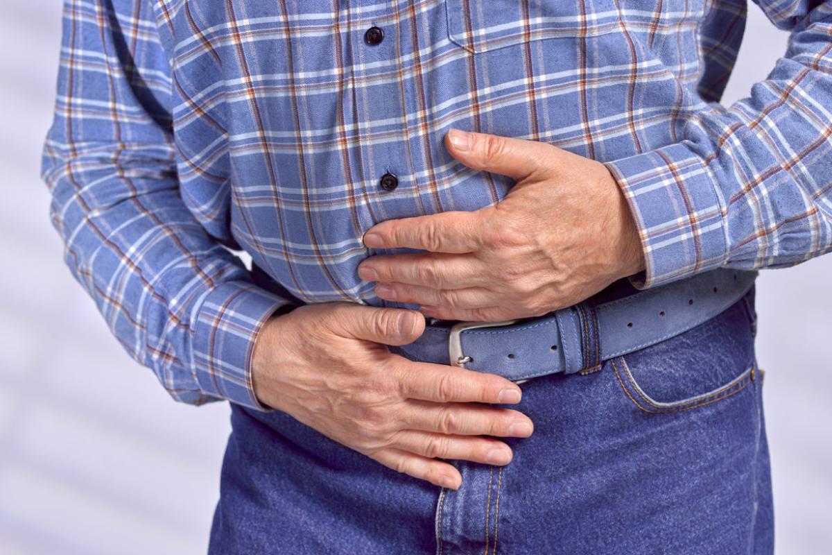 A man clutching his stomach.